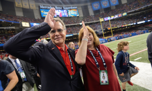 Chancellor Vitter and his wife, Sharon, displaying the landshark signal