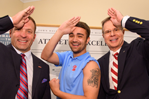 Athletic Director Ross Bjork and Chancellor Jeffrey Vitter go fins-up for a photo with former Rebel Black Bear mascot Jordan Richardson. Photo by Robert Jordan/Ole Miss Communications