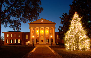 The Lyceum building at night with christmas tree and lights